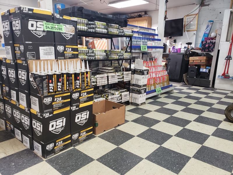 Interior aisle stacked with adhesive, caulking and building supplies