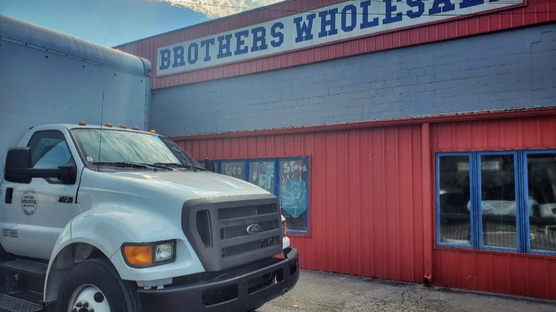 Brothers Wholesale delivery truck parked outside the store